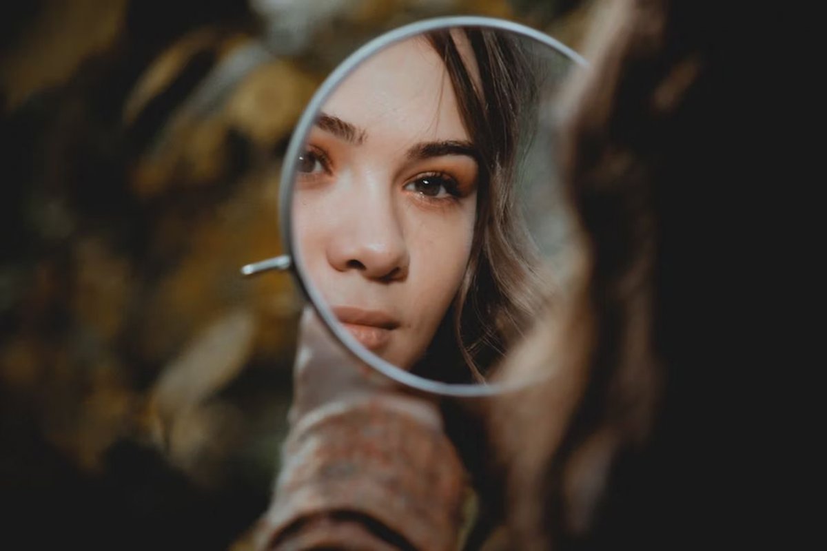 молодая женщина смотрится в зеркало