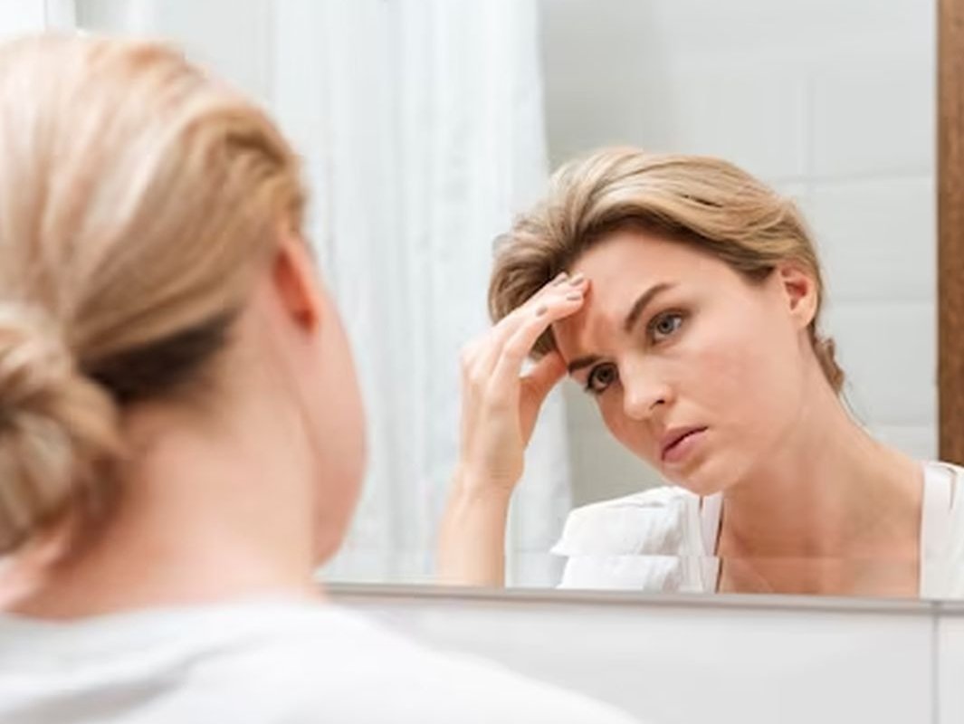 женщина смотрит в зеркало